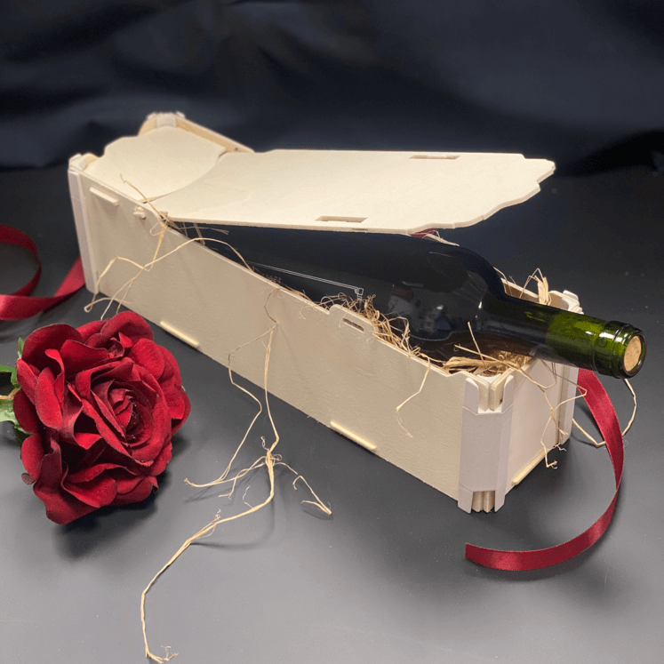 Caja de madera Sincla abierta con una botella de vino tinto sobre paja, junto a una rosa roja